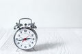 Alarm clock at empty locker on white background