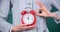 Alarm clock in female hands close up. Teachers attributes. Alarm clock in hands of teacher or educator classroom