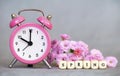 Alarm clock and flowers, spring forward, daylight savings time concept Royalty Free Stock Photo