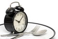 Alarm clock with fork and knife on the plate on white. Time to eat. Healthy food concept Royalty Free Stock Photo