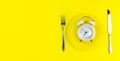 Alarm clock with fork and knife on the table. Time to eat, Breakfast, Lunch Time and Dinner concept Royalty Free Stock Photo