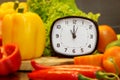 Alarm clock with fresh vegetables for cooking,focus of alarm clock Royalty Free Stock Photo