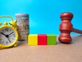 Alarm clock,gavel,banknotes and colored block with copy space Royalty Free Stock Photo