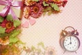 Alarm clock and gift box with roses bouquet with space copy on pink polka dot background Royalty Free Stock Photo