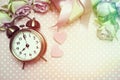 Alarm clock and gift box with roses bouquet with space copy on pink polka dot background Royalty Free Stock Photo