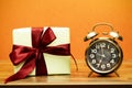 Alarm Clock And Gift Box wood table Royalty Free Stock Photo