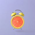 Alarm clock with grapefruit Royalty Free Stock Photo