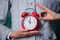 Alarm clock in hands of teacher or educator classroom background. School discipline concept. Schedule and regime. Right