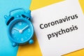 Alarm clock and note with text. The concept of how long the psychosis due to coronavirus will last Royalty Free Stock Photo