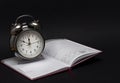 Alarm clock and notebook on black background, 2019 Royalty Free Stock Photo