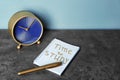 Alarm clock and notebook with written text TIME TO STUDY on table. Time management concept