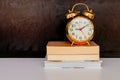 Alarm clock old vintage gold and book over white on black background. with copy space add text Royalty Free Stock Photo