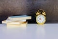 Alarm clock old vintage gold and book over white on black background. with copy space Royalty Free Stock Photo