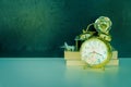 Alarm clock old vintage gold and book - plane plastic. over white on black background.