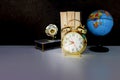 Alarm clock old vintage gold and globe plastic - book, gramophone over white on black background Royalty Free Stock Photo