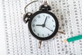Alarm clock, optical form of standardized school test with bubble and black pencil, answer sheet, education concept