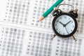 Alarm clock, optical form of standardized school test with bubble and black pencil, answer sheet, education concept Royalty Free Stock Photo