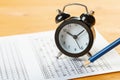 Alarm clock, optical form of standardized school test with bubble and black pencil, answer sheet, education concept