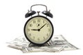 Alarm clock over heap of money isolated Royalty Free Stock Photo