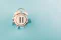 Alarm clock with pause sign, take a break, menopause concept, hormone replacement therapy Royalty Free Stock Photo