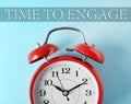 Alarm clock and phrase TIME TO ENGAGE on blue background, closeup Royalty Free Stock Photo