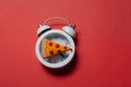 Alarm clock with a piece of pizza.  Pizza time. Snack time Royalty Free Stock Photo