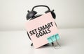 alarm clock with pink sticker with the text set smart goals Royalty Free Stock Photo