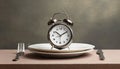 Alarm clock and plate with cutlery . Concept of intermittent fasting, lunchtime, diet and weight loss Royalty Free Stock Photo