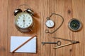 Alarm clock, pocket watch and a compass Royalty Free Stock Photo