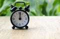 Alarm clock pointing at 12pm with customizable background space for text or ideas. Time concept. Royalty Free Stock Photo