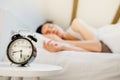 Alarm clock ringing.Woman waking up in early morning for work.Obstructive sleep apnea effects.Mental stress sleep depression. Royalty Free Stock Photo