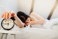 Alarm clock ringing.Woman waking up in early morning for work.Obstructive sleep apnea effects.Mental stress sleep depression.