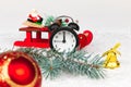 Alarm clock, santa claus on a sleigh, a blue spruce branch, a golden bell and a Christmas tree toy ball Royalty Free Stock Photo