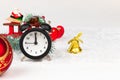 Alarm clock, santa claus on a sleigh, a blue spruce branch, a golden bell and a Christmas tree toy ball Royalty Free Stock Photo