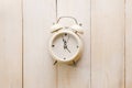 Alarm clock showing almost 12 o clock, on old white wooden floor background Royalty Free Stock Photo