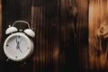 Alarm clock showing almost 12 o clock, on old wooden floor background Royalty Free Stock Photo