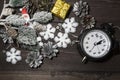 An alarm clock, snowflakes, a snow-covered spruce branch and silvery cones Royalty Free Stock Photo