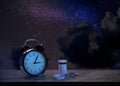 Alarm clock and soporific pills on grey table against night sky with stars. Insomnia Royalty Free Stock Photo