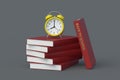 Alarm clock on stack of books with inscription back to school. Education concept