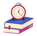 Alarm clock stack books, suggesting time management deadline. Education concept exam preparation