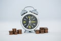 Alarm clock with stack of coins Royalty Free Stock Photo