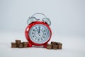 Alarm clock with stack of coins Royalty Free Stock Photo