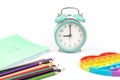 School items. Alarm clock, notebooks, pencils for drawing on a white background. Concept of education, back to school, creativity Royalty Free Stock Photo