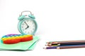 School items. Alarm clock, notebooks, pencils for drawing on a white background. Concept of education, back to school, creativity Royalty Free Stock Photo