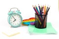 School items. Alarm clock, notebooks, pencils for drawing on a white background. Concept of education, back to school, creativity Royalty Free Stock Photo