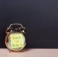 Alarm clock and sticker with text back to school Royalty Free Stock Photo