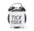 Alarm clock and sticky note with words TICK TOCK Royalty Free Stock Photo