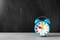 Alarm clock on table against color background Royalty Free Stock Photo