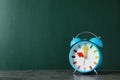 Alarm clock on table against color background Royalty Free Stock Photo
