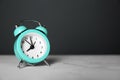 Alarm clock on table against dark background. Time management concept Royalty Free Stock Photo